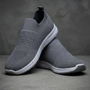 Men's grey breathable slip-on walking shoes with lightweight cushioned sole and knitted mesh upper for casual wear, travel, gym, and everyday comfort.