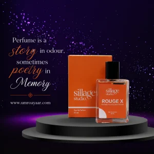 Sillage Studio Rouge X Eau De Parfum 50ml glass bottle next to orange box on a black pedestal against a cosmic purple starry background